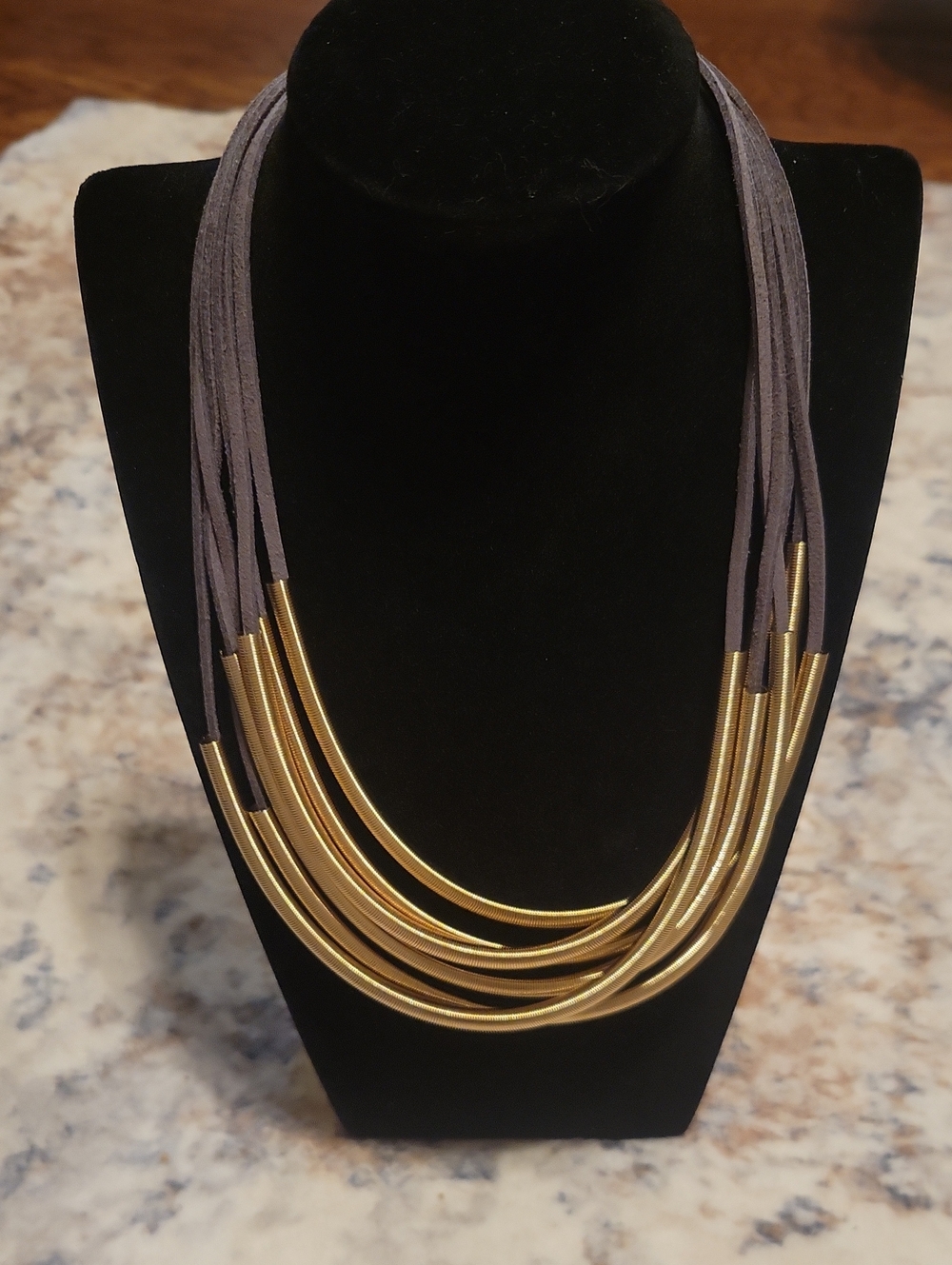 Layered Gold-Tone Tube Necklace on Gray Cord